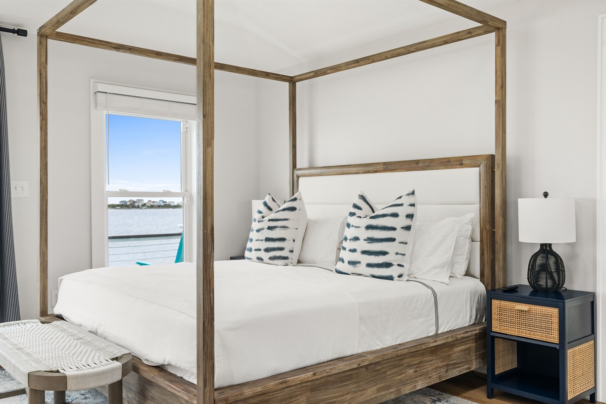 Luxurious 3rd-floor king master suite featuring a stunning canopy bed and beautiful waterfront views