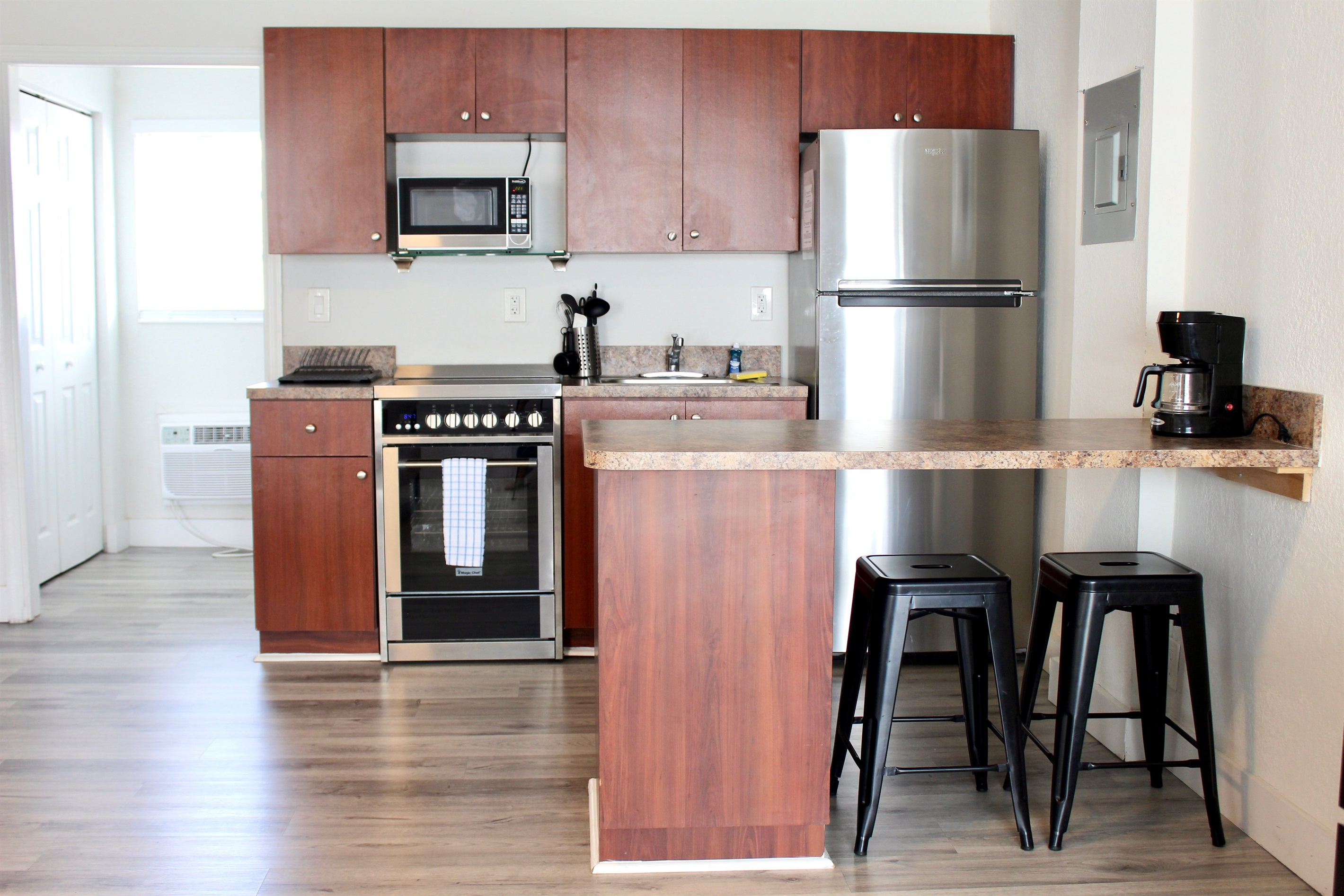 Fully stocked kitchen, stainless steel. 2m video tour link includes open cabinets to show supplies.