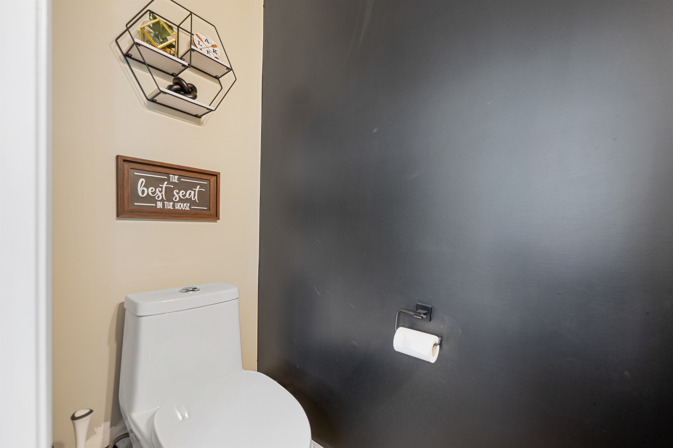 Located on the first floor just off the main living space, this half bath features a clean, modern design.