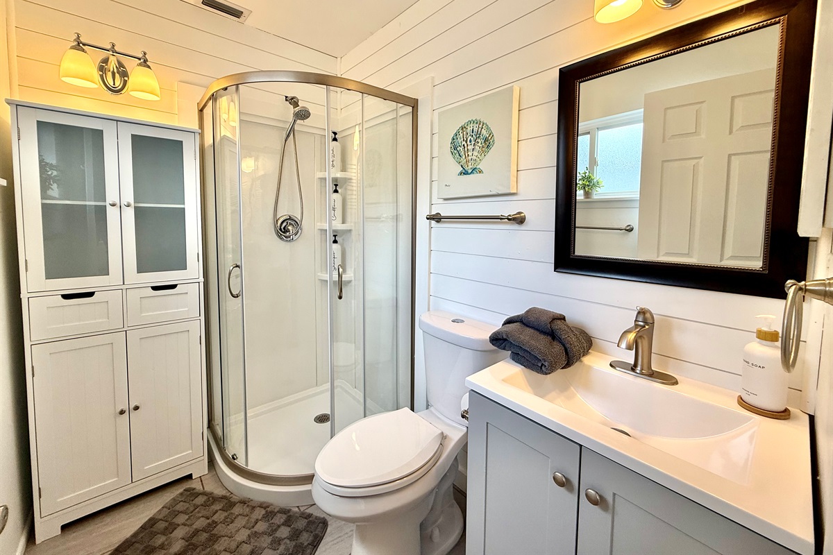 A glass-enclosed shower and modern vanity make this bathroom a relaxing escape.