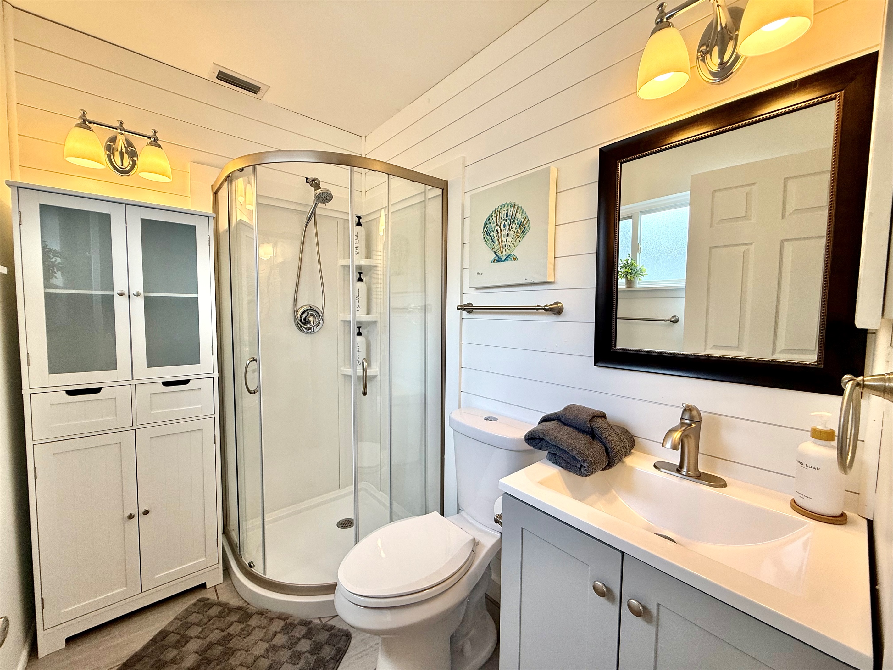 A glass-enclosed shower and modern vanity make this bathroom a relaxing escape.