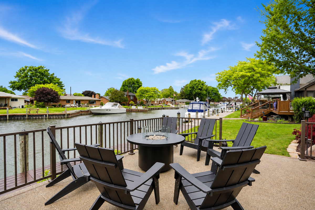 Waterfront seating area with fire pit and canal views—perfect for relaxing, socializing, and enjoying peaceful lakefront living.