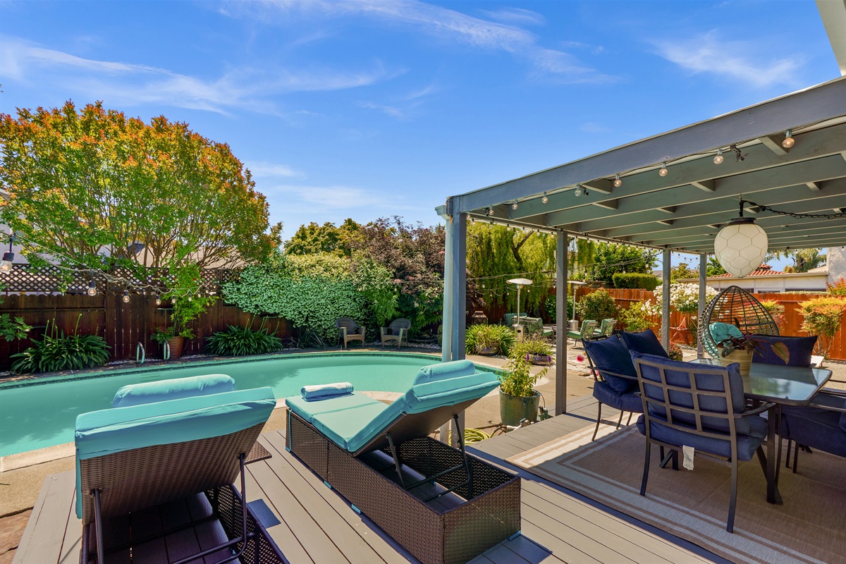 Private backyard retreat with a sparkling pool, outdoor seating, and space to relax and enjoy Napa Valley’s beautiful weather.