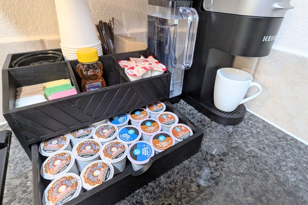 Fully stocked coffee bar includes: coffee, hot chocolate, decaf, tea k-cups • variety of sugar and sweeteners • local honey • creamer cups • k-cup maker with multiple brewing options • to-go cups with lids