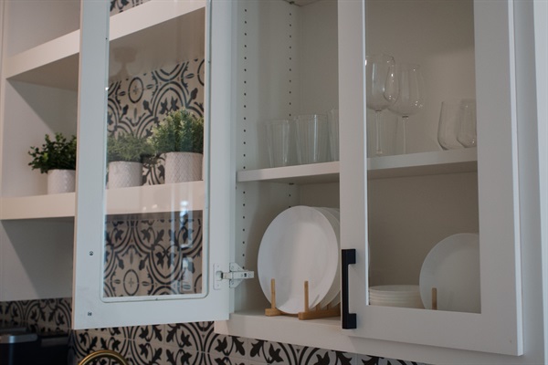 Basic dishes are provided, including plates, bowls, cups, mugs, and wine glasses in both stemmed and stemless styles. Corkscrew provided for opening wine bottles.