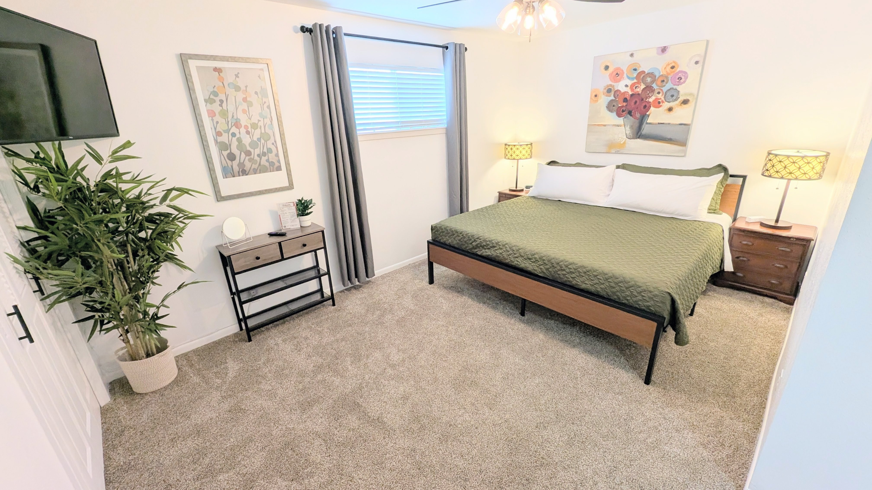 Designed for comfort, the king bedroom includes blackout curtains, a ceiling fan, charging stations, Roku TV, closet space, and plenty of plush pillows and bedding.