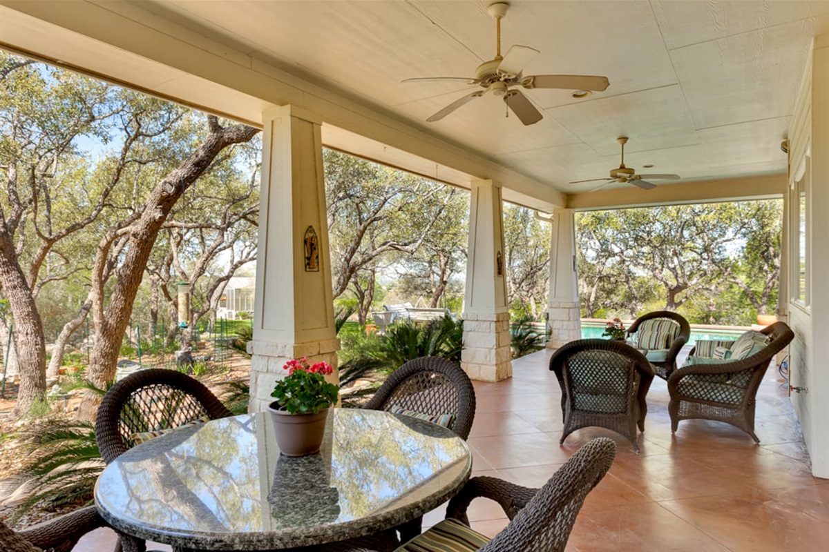 Covered porch with dining and lounging areas