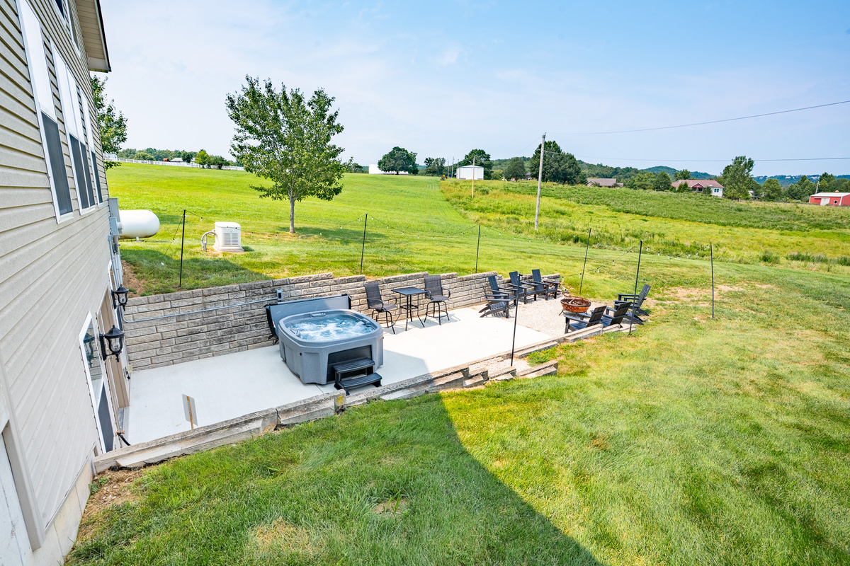 Backyard bliss. Firepit, a new hot tub, seating, and endless sky make for unforgettable evenings.