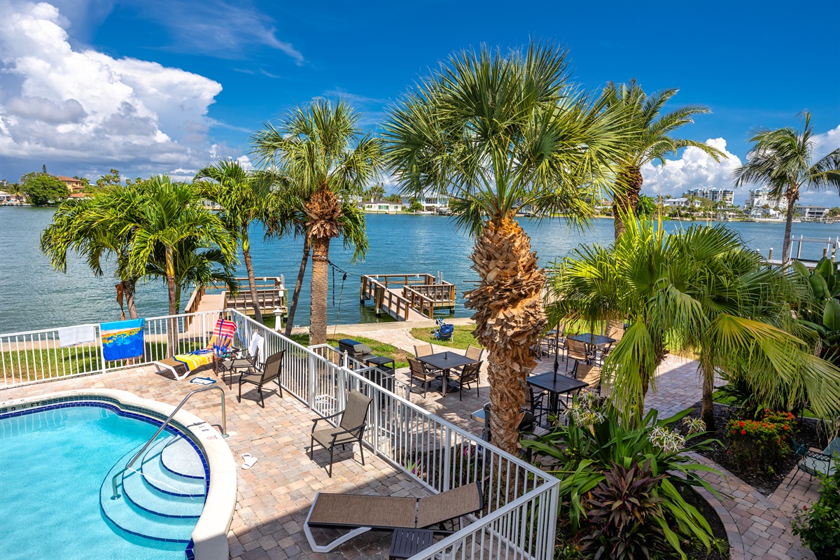 Beautiful waterfront pool area with patio for large groups