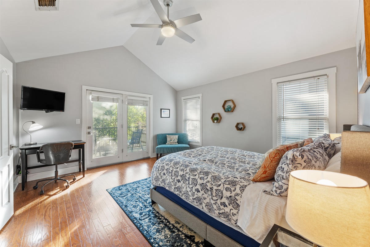 Master Bedroom with Smart TV and balcony overlooking backyard