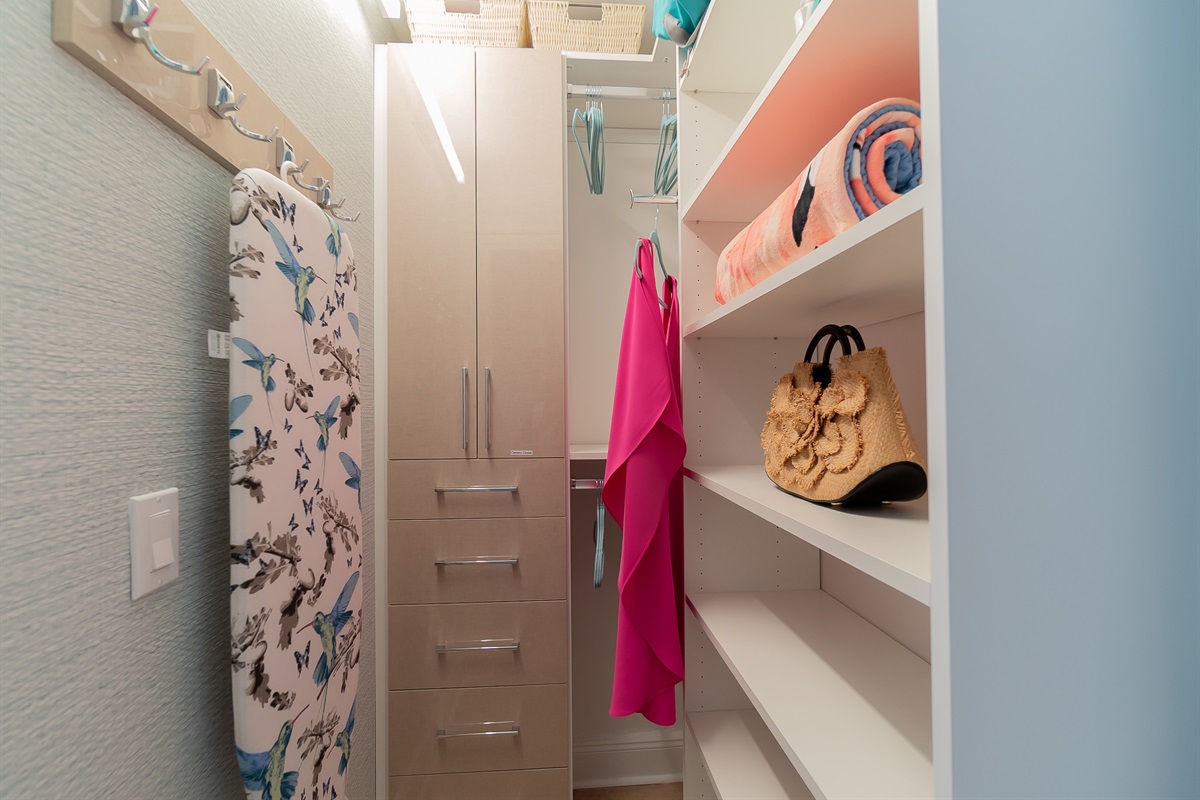 Gorgeous custom wallpapered closet.  Shelves, drawers, hooks and hanging space for your wardrobe.