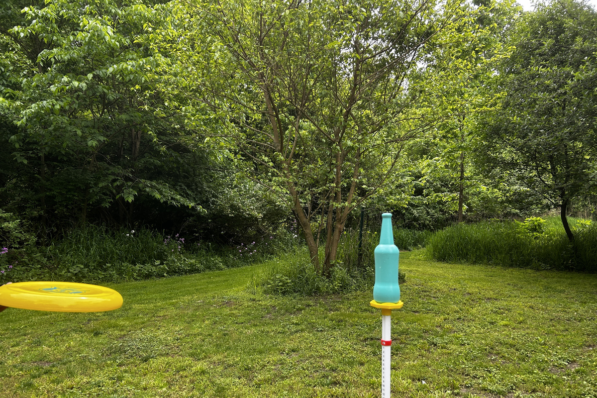 How easy is it for you to knock the bottle off with a frisbee? Increase the difficulty level by having your opponent guard the bottle.