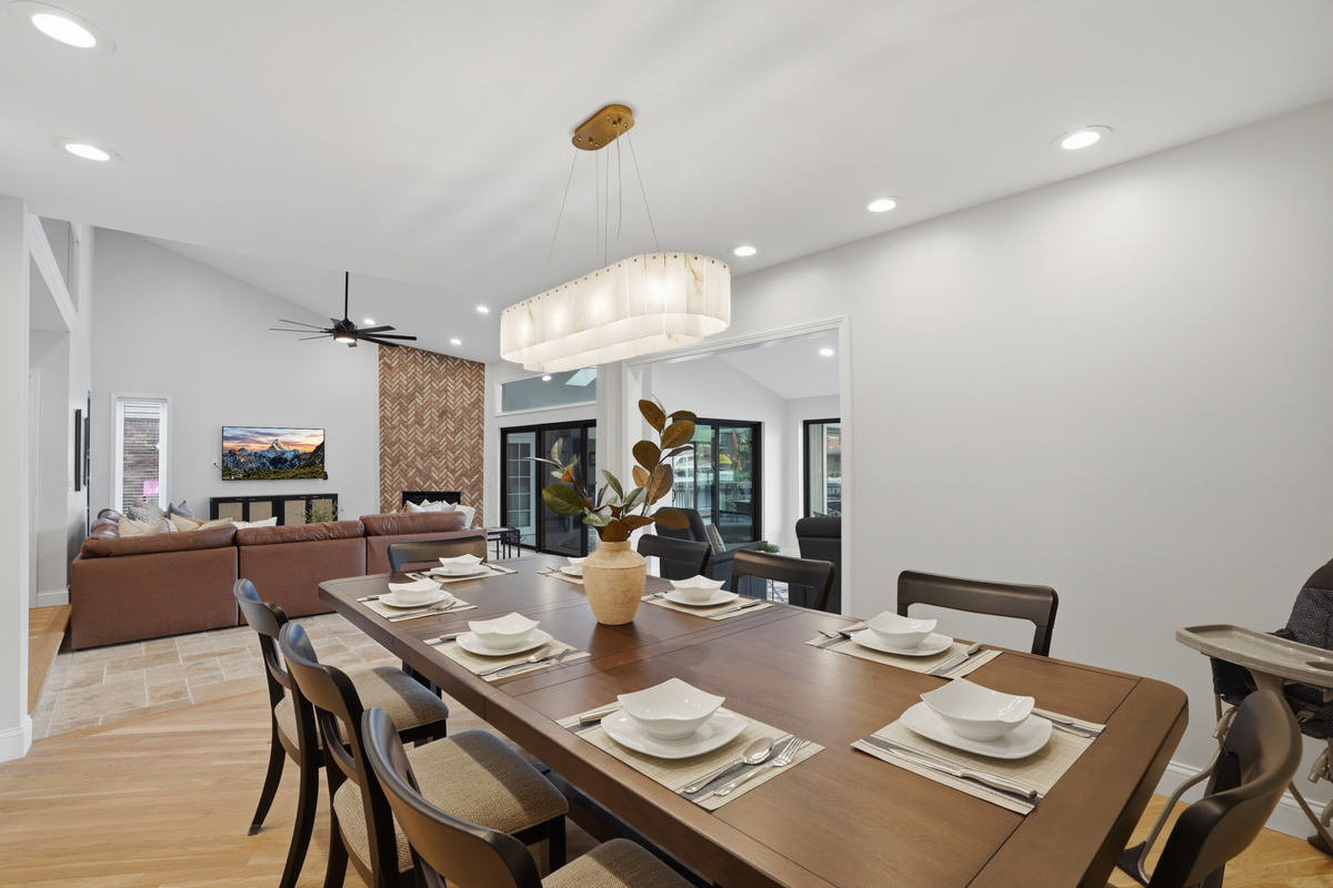 Enjoy meals and game nights around the spacious dining table, perfectly positioned within the open-concept living area for gathering and entertaining.