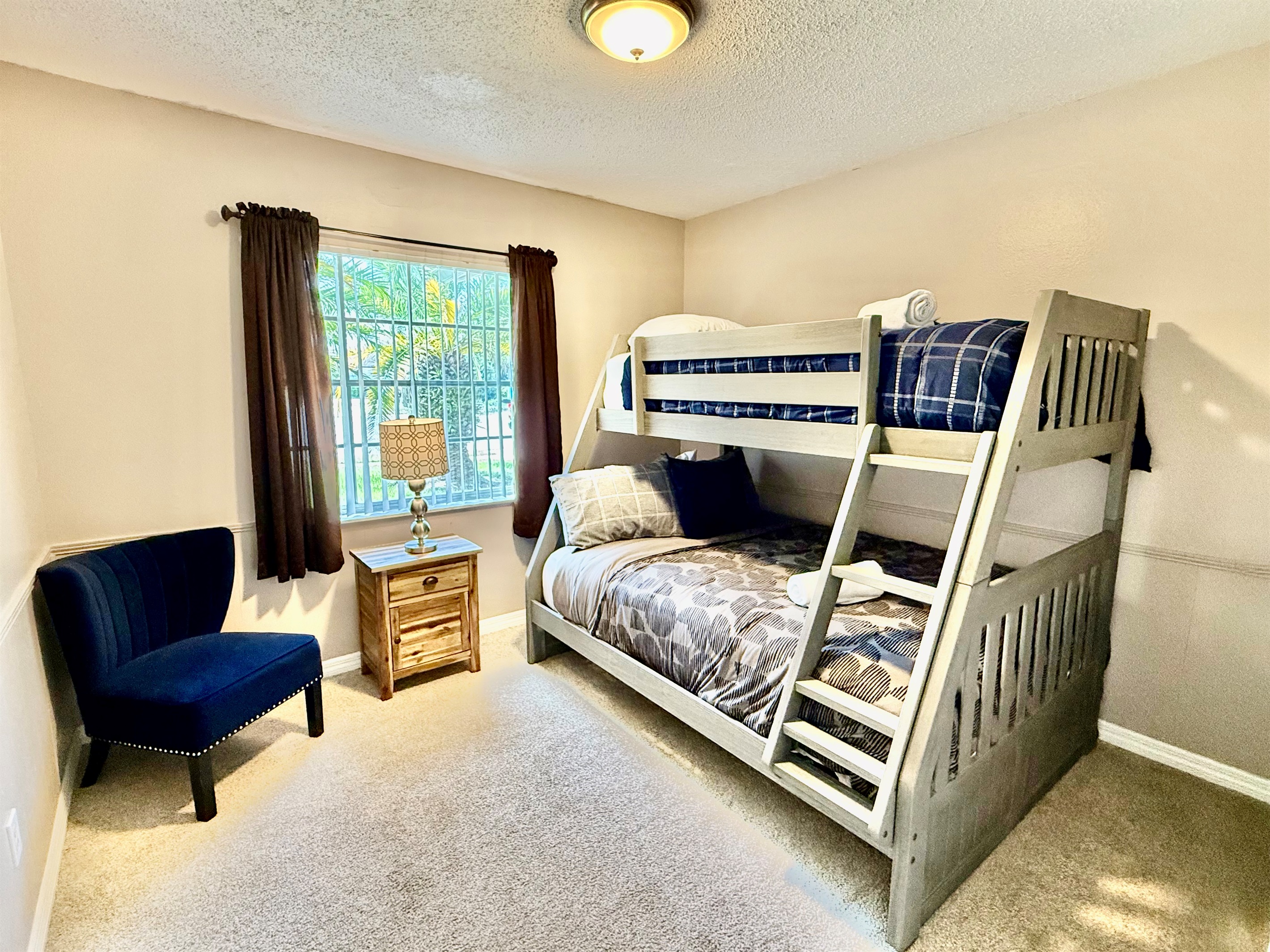 Ideal for families or groups, this inviting bedroom offers two bunk beds, plush carpeting, and thoughtful decor to make everyone feel at home.