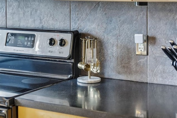 Fully equipped kitchen with stainless steel stove, microwave, and cooking essentials. Enjoy convenient meal prep with modern finishes, ample counter space, and everything you need for a comfortable stay.