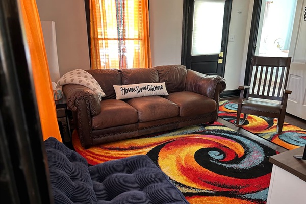 Sink into the comfy leather sofa. Blue chair opens to a twin bed.