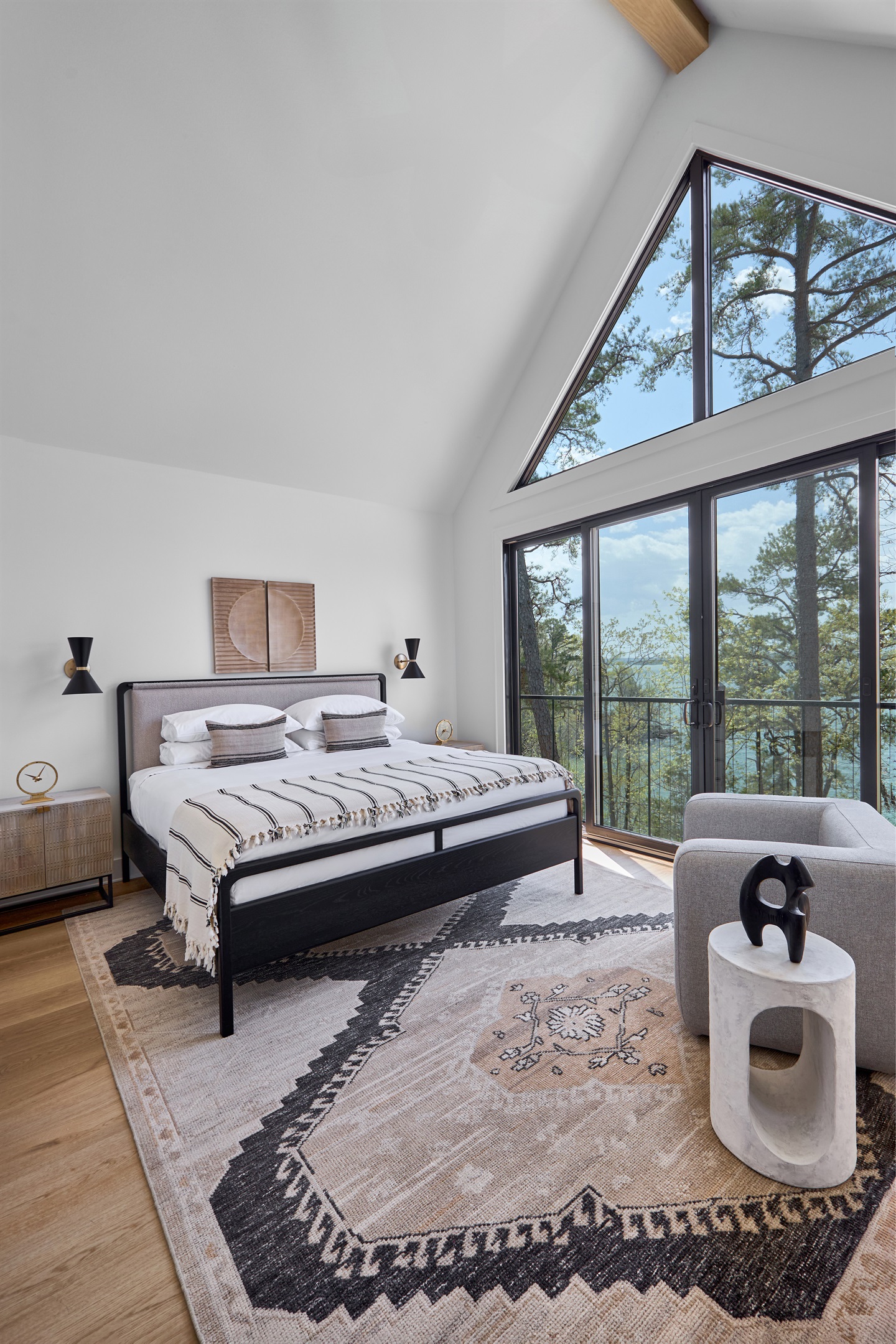 Take in panoramic lake views from the upper king suite, where vaulted ceilings and large windows offer a front-row seat to nature.