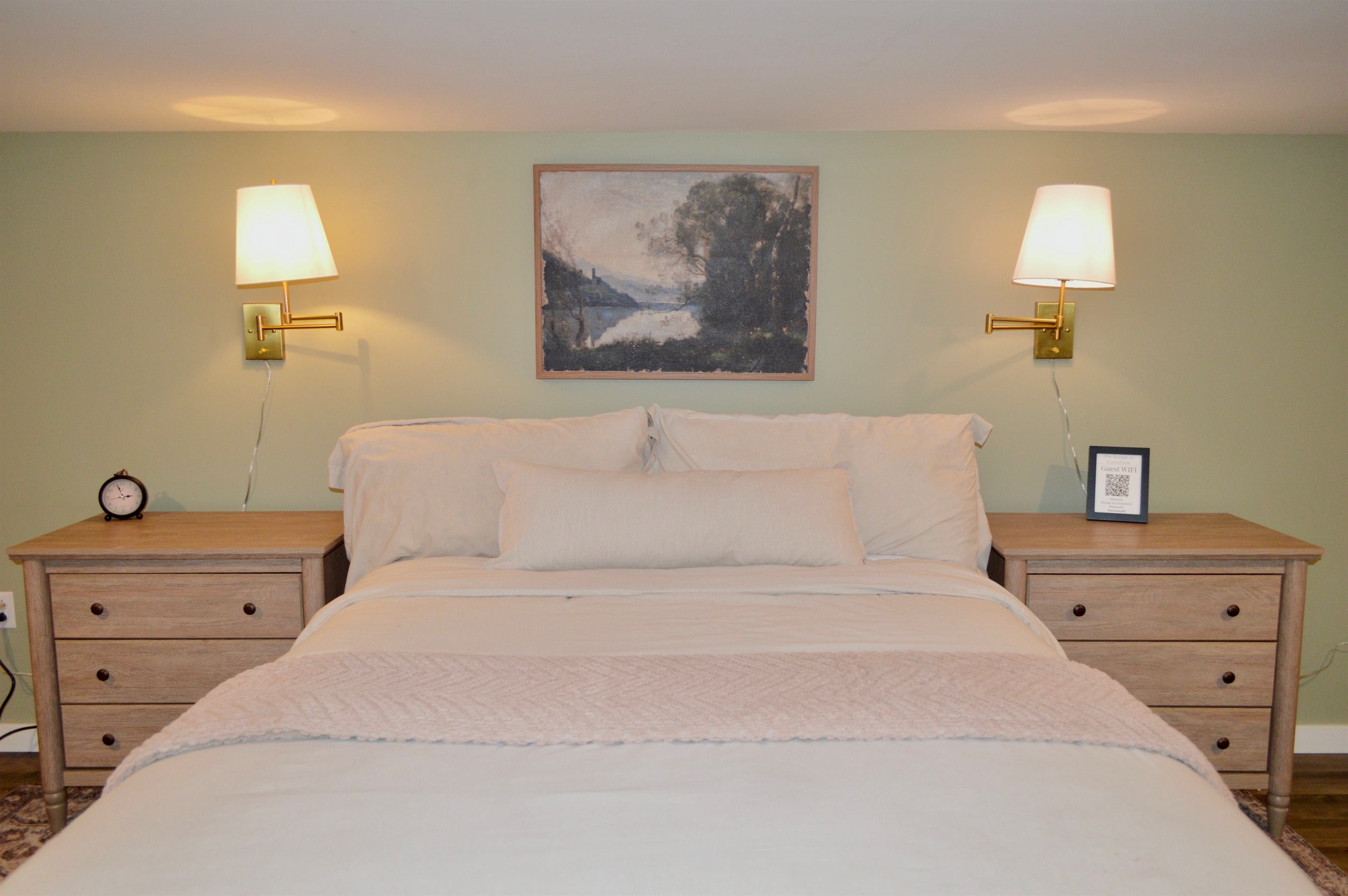 Comfortable queen bed with clean, modern bedding