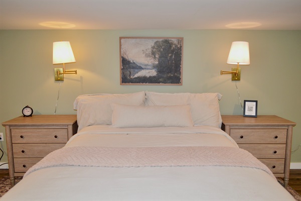 Comfortable queen bed with clean, modern bedding