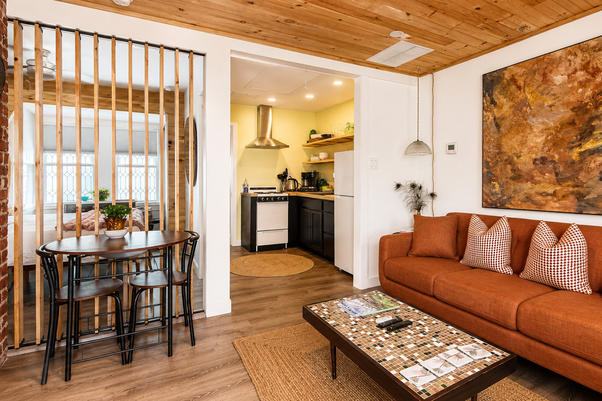 The wooden slat wall in the living room opens and closes for light and privacy
