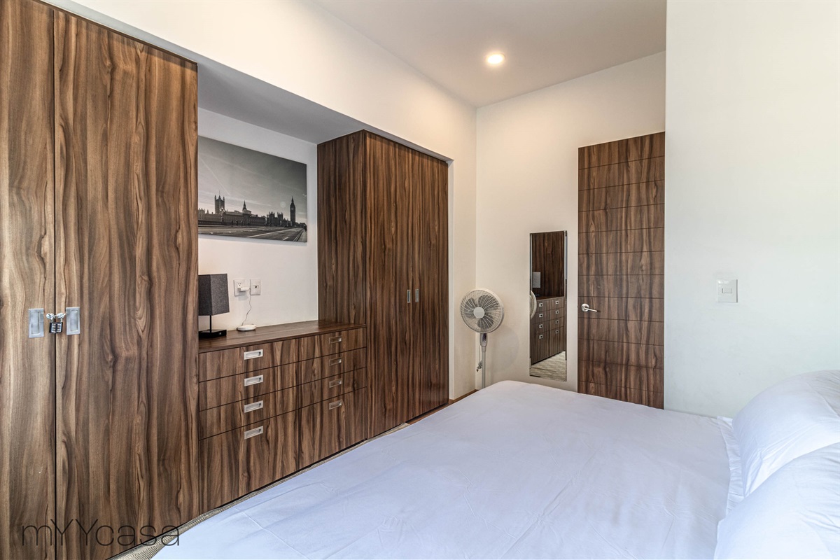 Spacious bedroom 2 with a king sized bed and ample wardrobe storage for your clothes