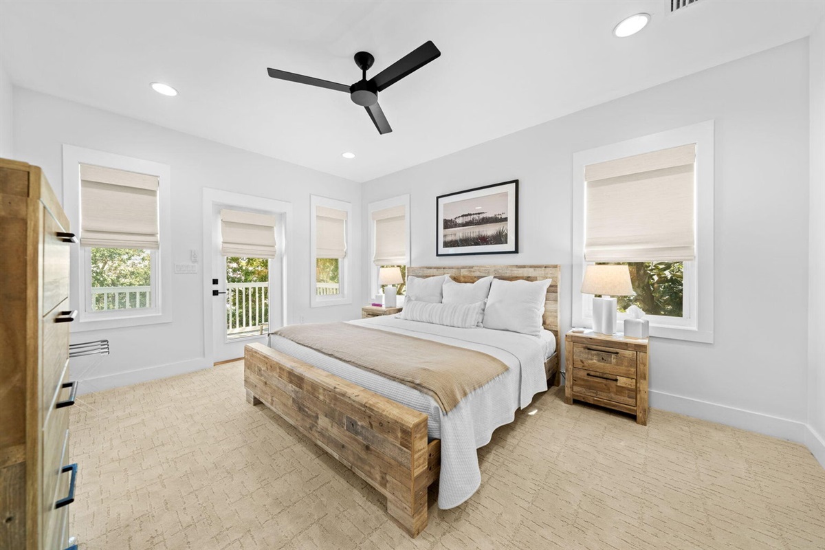 Secondary Suite offers another oversized bedroom with a king bed, dresser, wall mounted Smart TV, en-suite bath, private porch access, and a large closet.