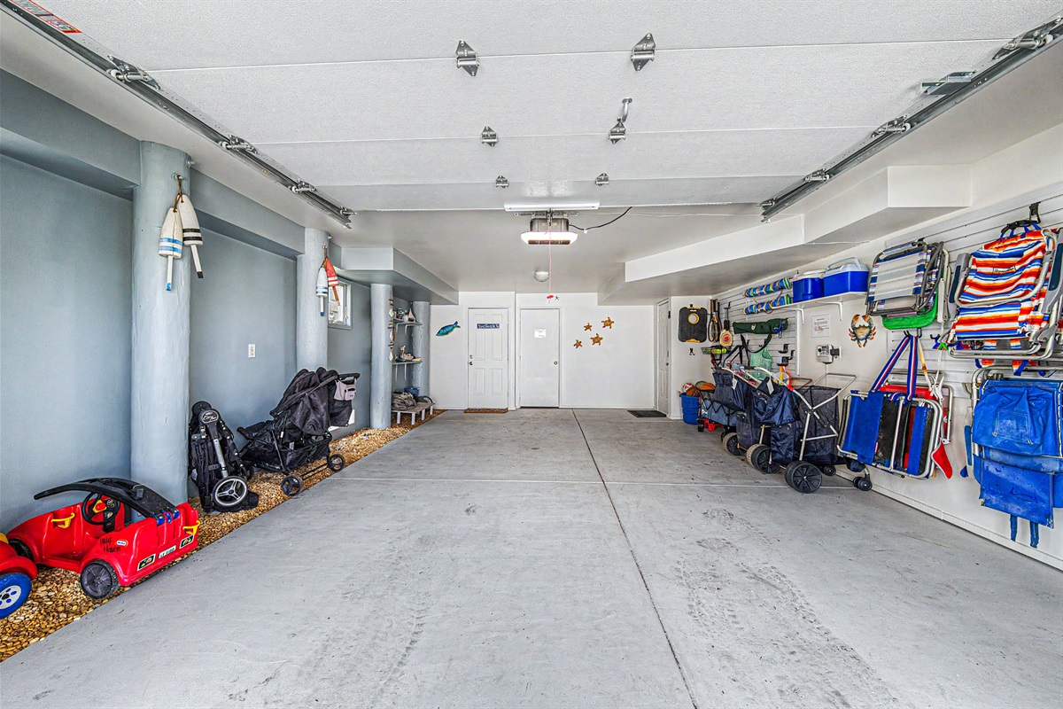 Renovated garage, filled with beach gear (umbrellas, carts, wagon, chairs, toys)