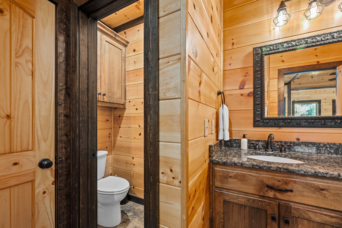 Cozy half bath with natural wood décor and rustic charm.