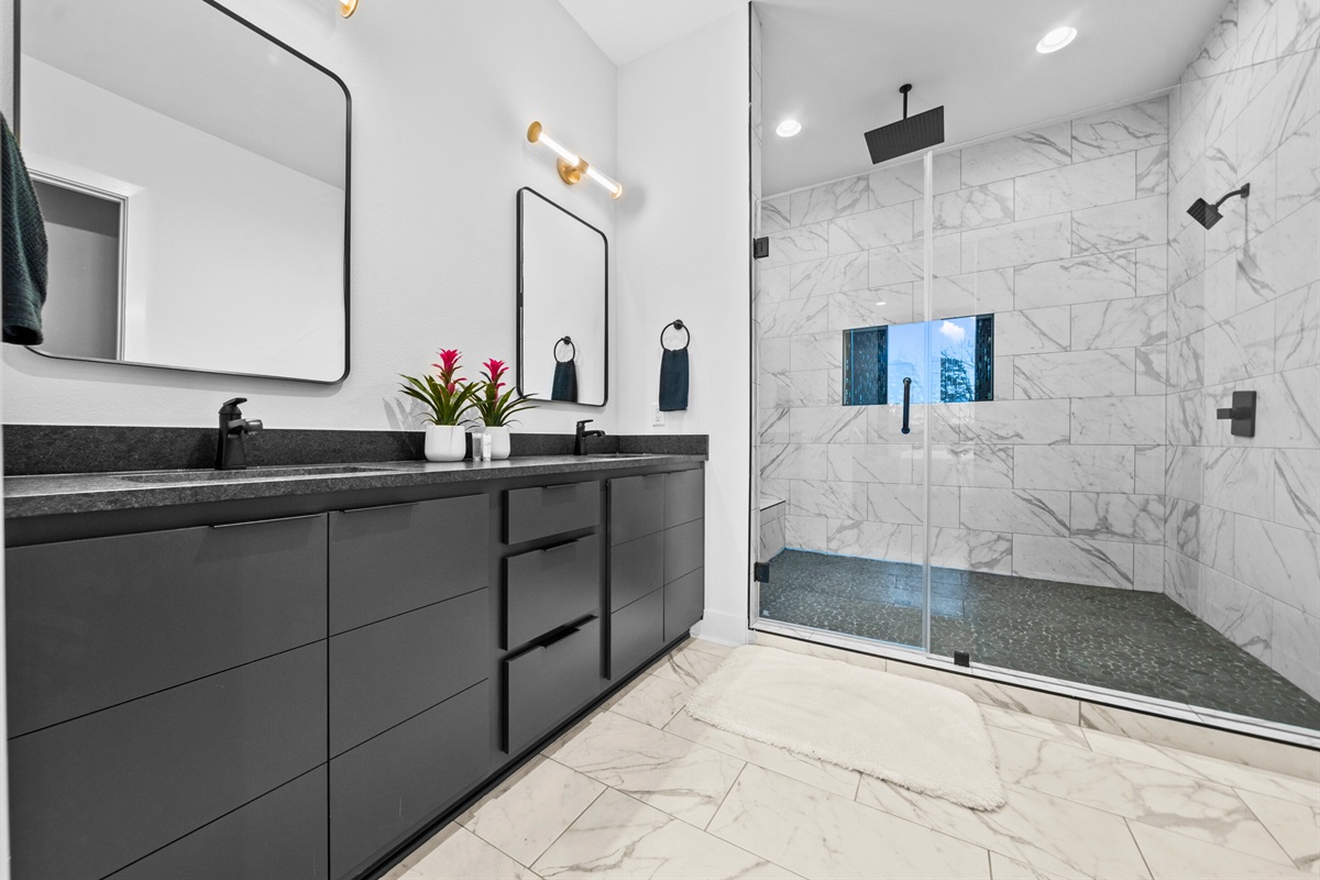 Step into this stunning walk-in shower, where elegant tilework and modern fixtures provide a luxurious and serene experience.