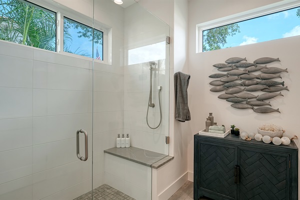 Spa-like shower experience with palm trees outside and aromatherapy spray