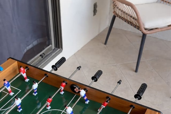 Spacious private balcony with direct access from the kitchen and Bedroom 4, complete with cozy string lights and a mini foosball table — perfect for evening gatherings or casual games.