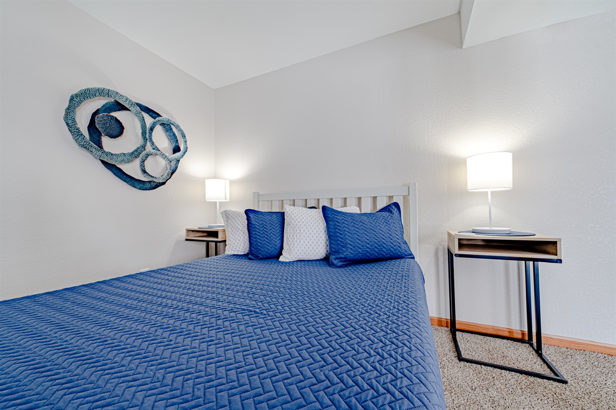 One of the comfy queen beds downstairs for a peaceful night sleep!