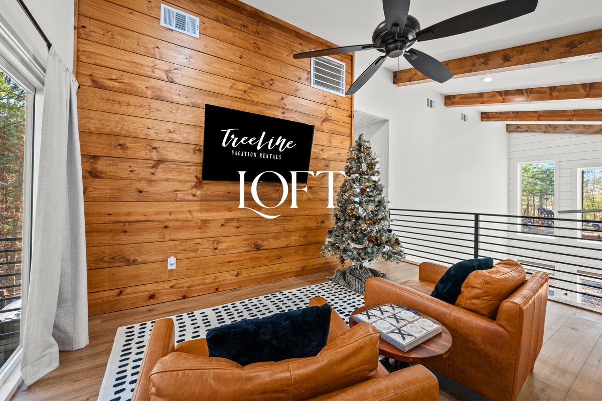 Upstairs, the loft opens into a flexible space designed for relaxing, playing games, or spending time together.