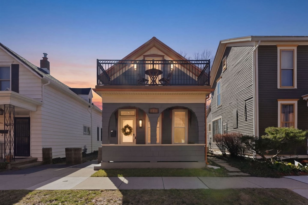 Charming front exterior with a welcoming porch and private upper balcony—perfect for relaxing mornings or evening drinks