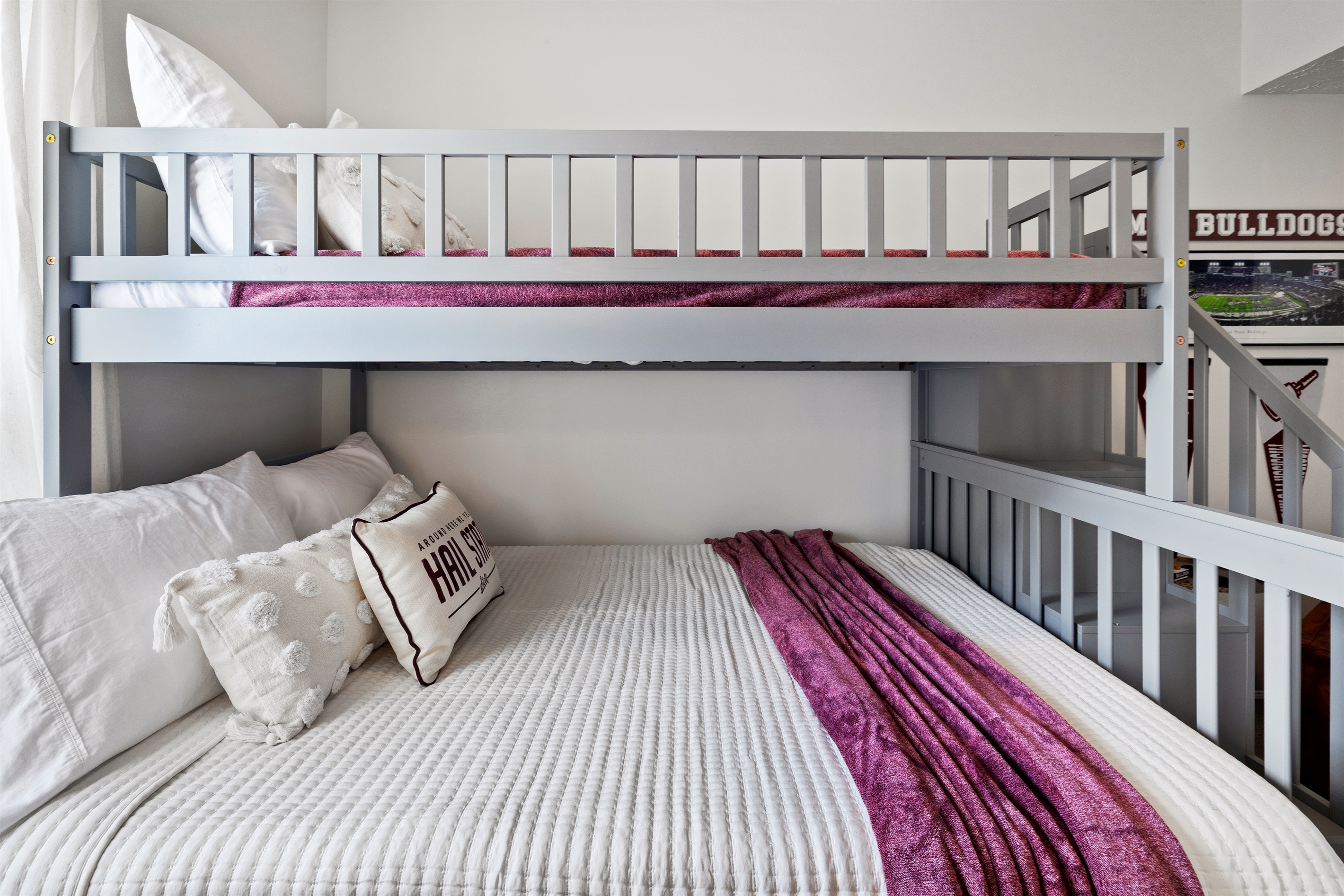Bottom bunk features a full bed for diverse sleeping needs.