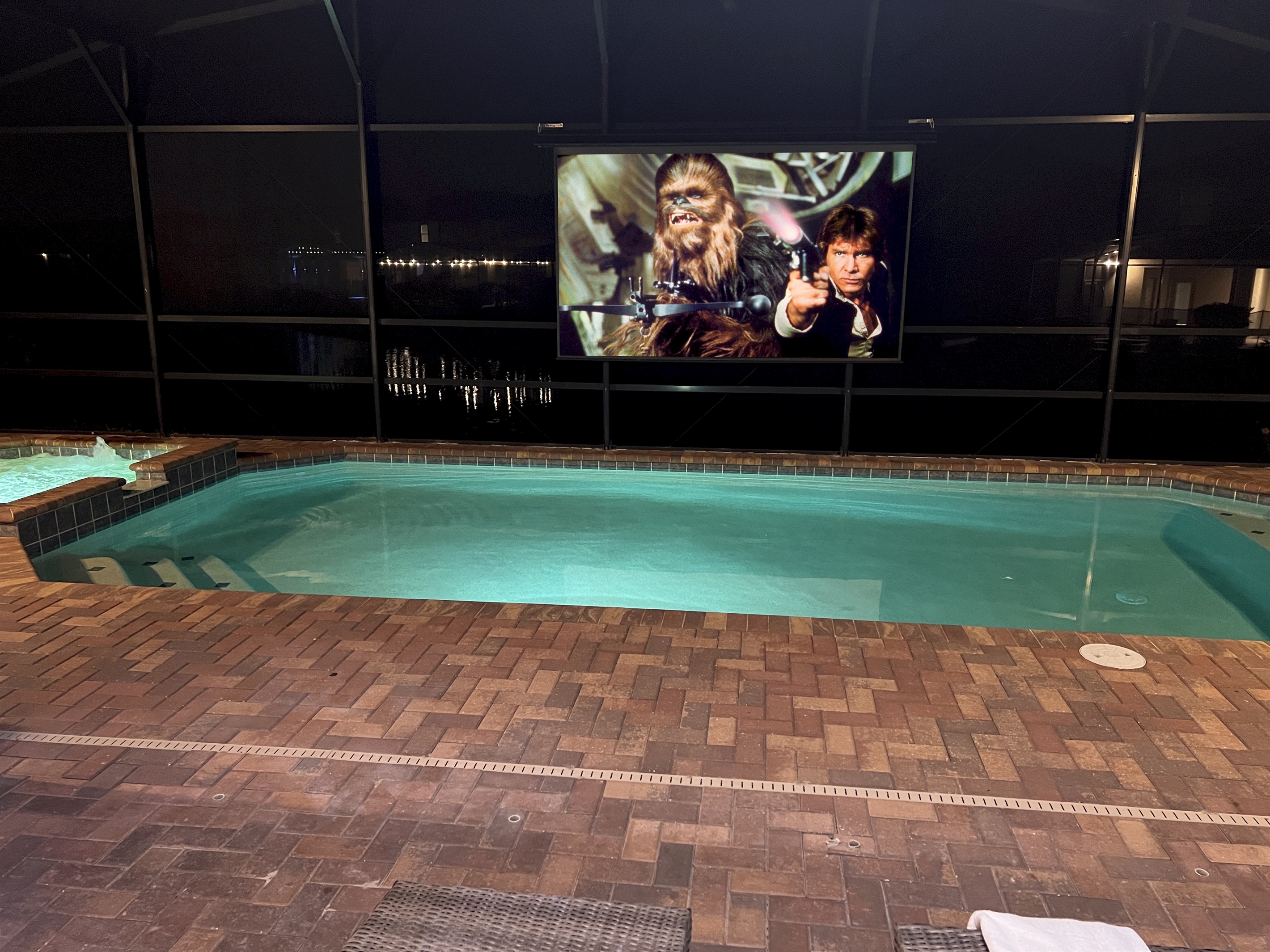 Enjoy The Poolside Theater Watching TV Or Movies