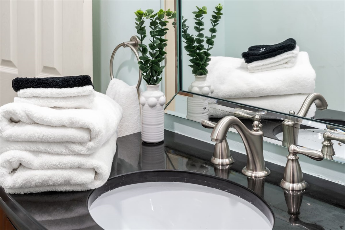 Crisp white towels, sleek finishes, and calming decor—our spa-inspired bathrooms are stocked and ready for your stay.
