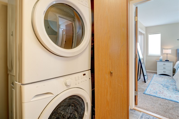 In-unit washer and dryer, stacked and tucked away for ultimate convenience.