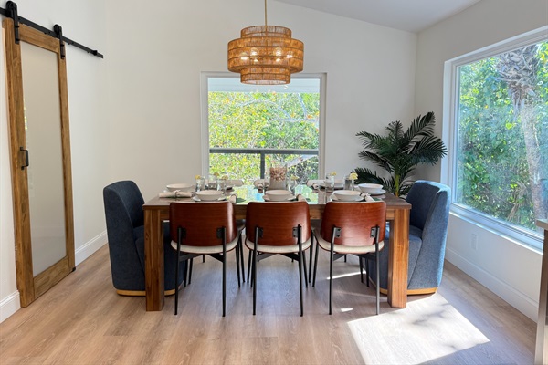 Comfortable dining surrounded by large windows and tropical views