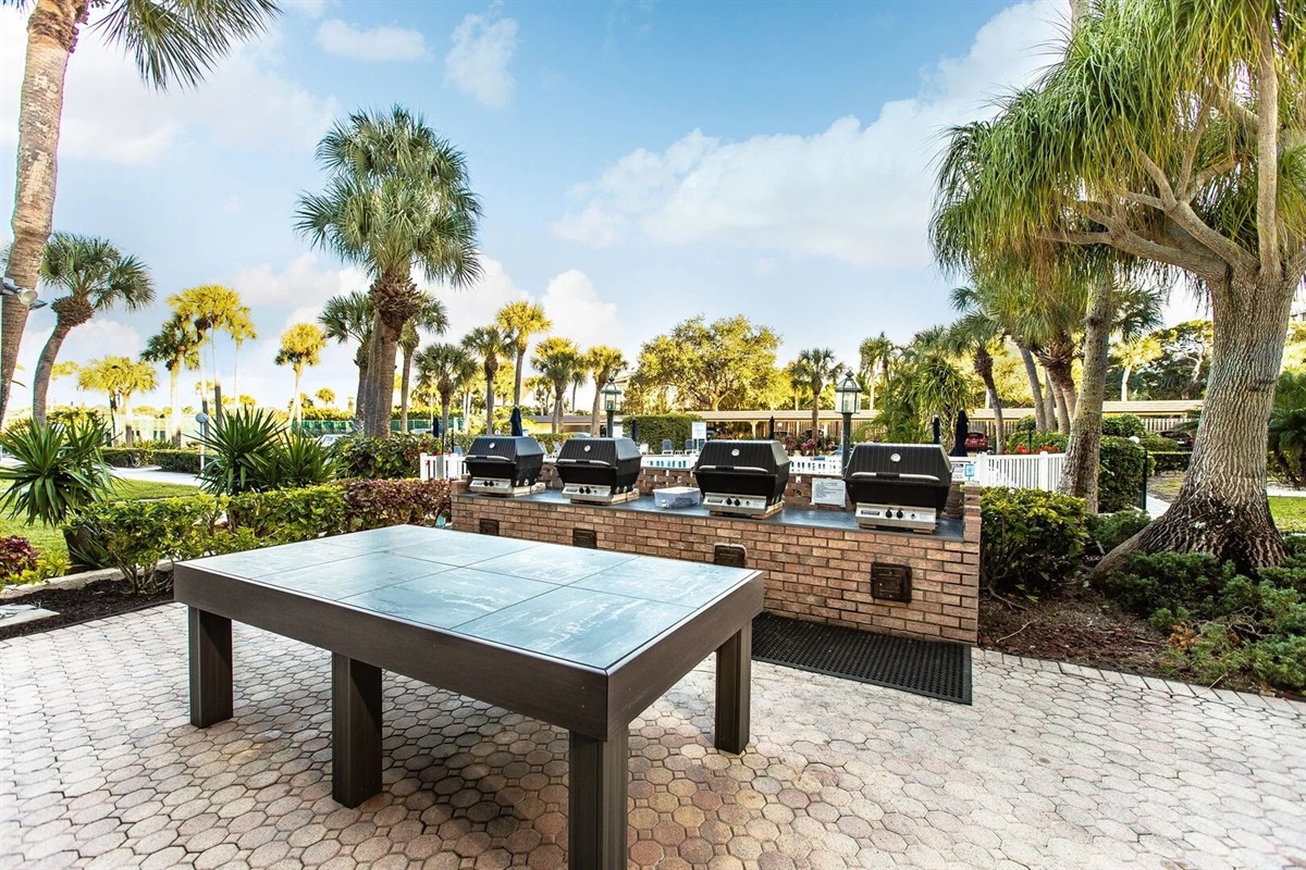 Outdoor grill under the palm trees.