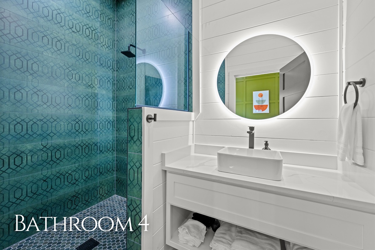Modern fixtures, clean design details, and bright lighting make this bathroom both stylish and functional for guests staying throughout the cabin.