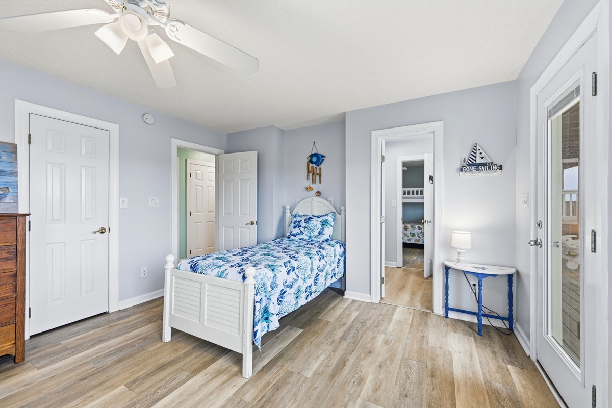A cozy twin bed and a jack and Jill bathroom makes this bunk room even more accommodating