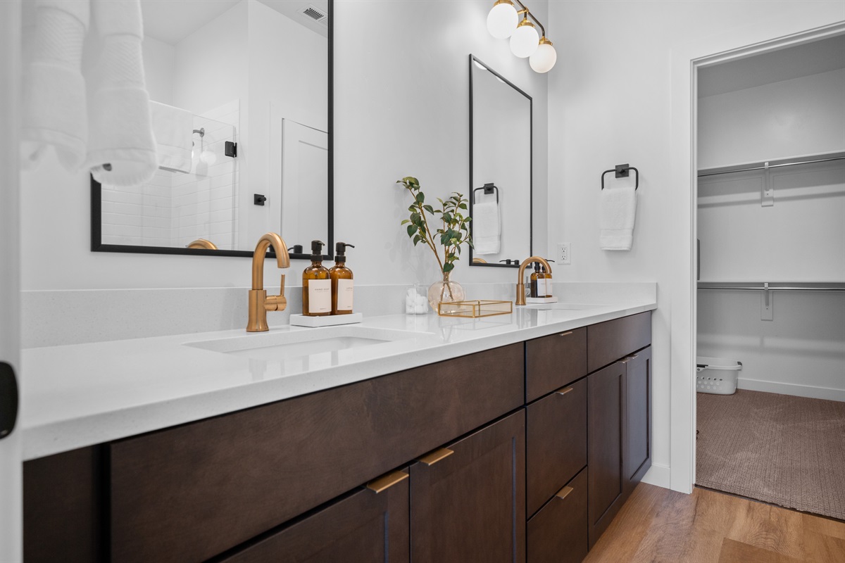 Elegant double vanity with modern fixtures, sleek quartz counters, and ample storage.