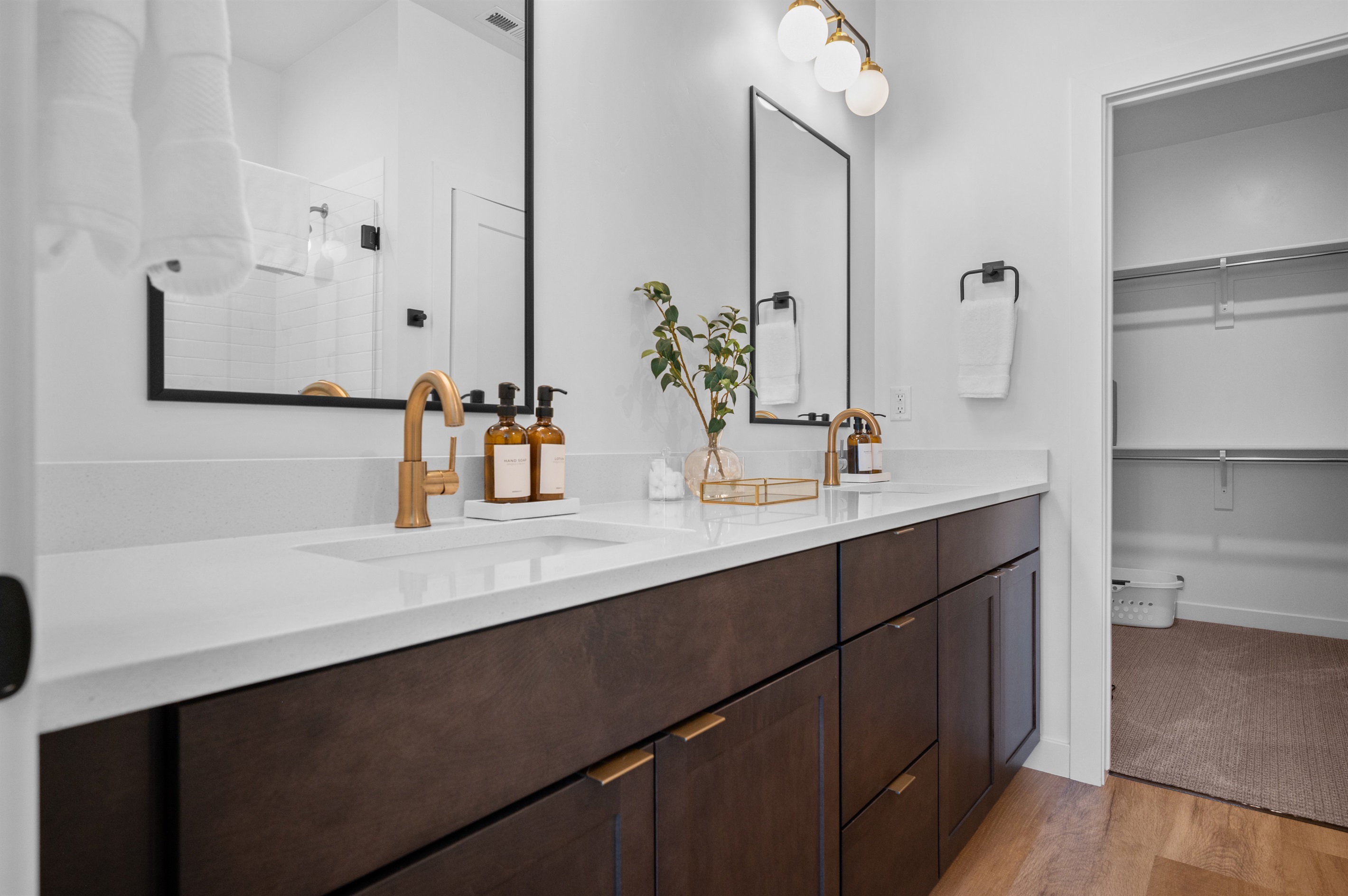 Elegant double vanity with modern fixtures, sleek quartz counters, and ample storage.