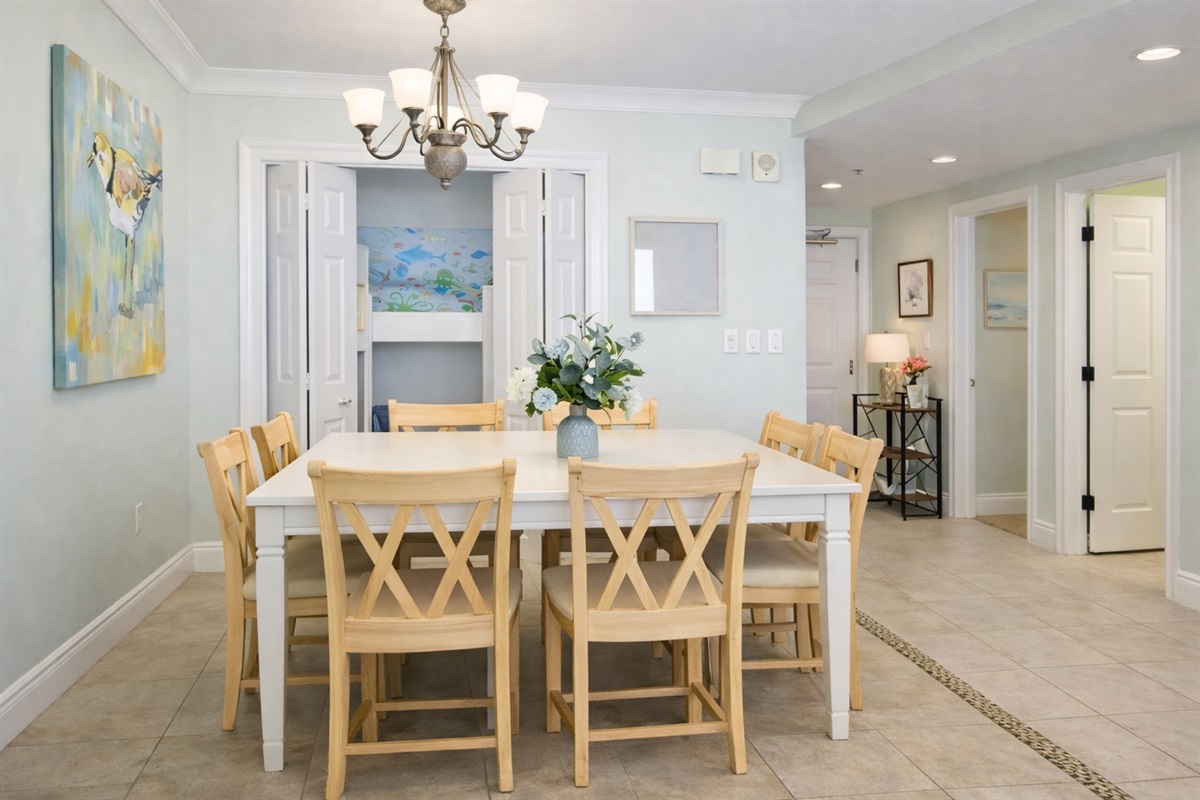 Bright coastal dining area with seating for six — perfect for family meals and game nights.
