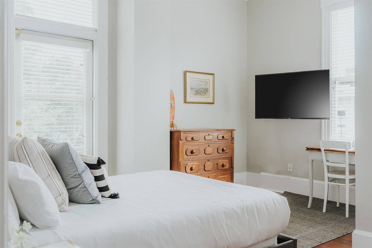 Spacious bedroom with views of both the backyard/pool as well as the side of the home provides plenty of natural light throughout the day.