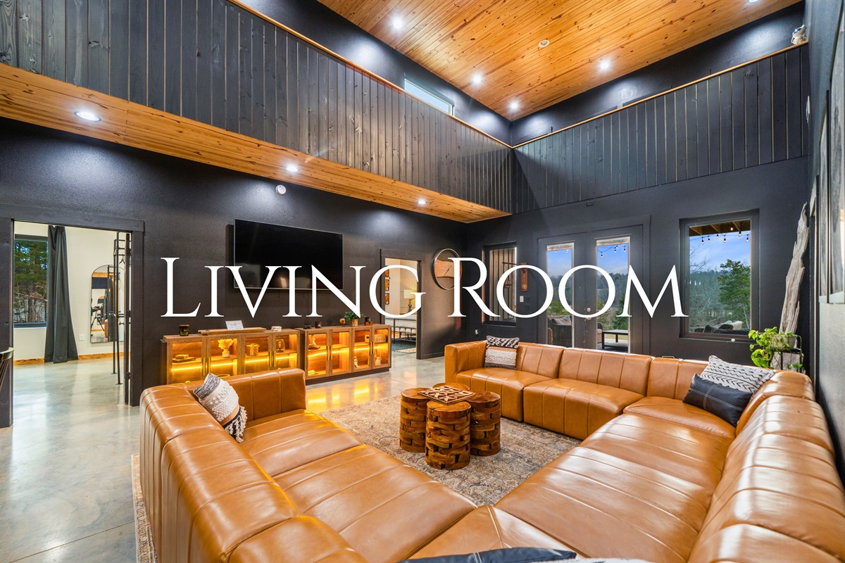 The living room welcomes you with plush seating, dramatic ceilings, and a layout that&rsquo;s perfect for relaxing after a full day of fun.