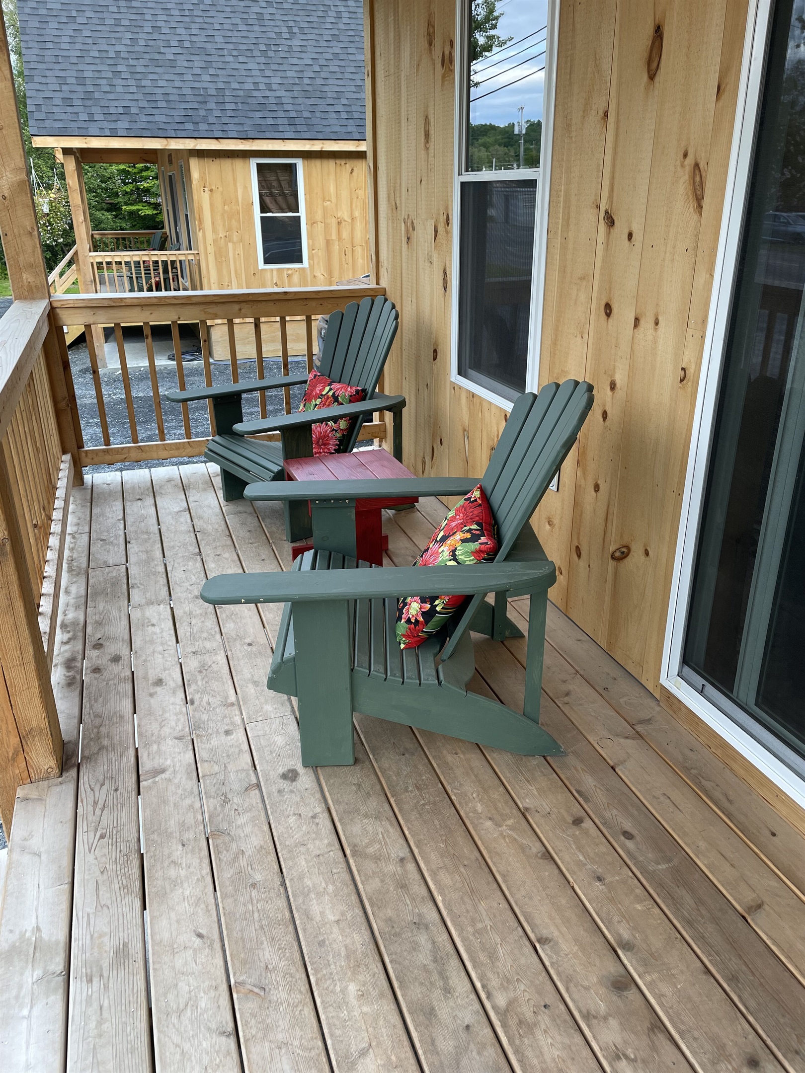 Front porch with Adirondack chairs with access to restaurants, shops, and lake!