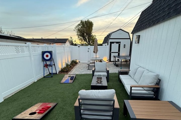 Backyard Seating and Fire Table. Outdoor Dining Table. Games: Ping Pong Table, Corn hole, Ax Throwing