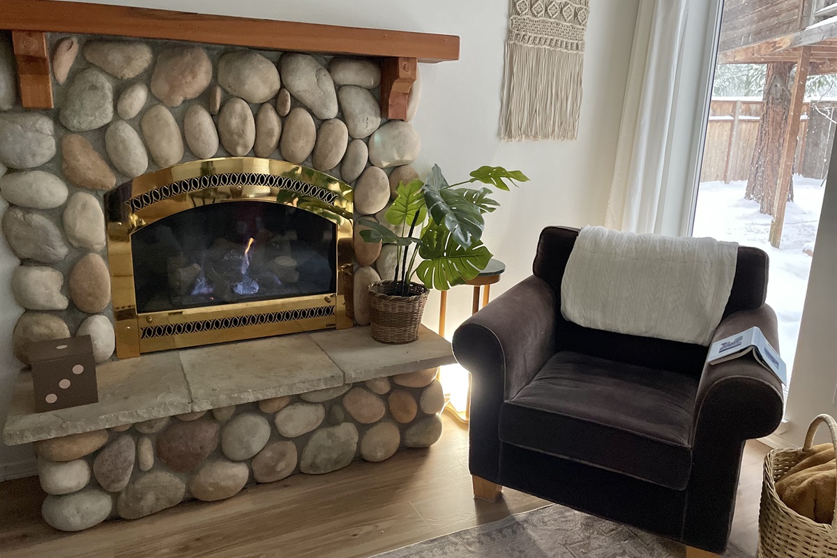 Cozy gas fireplace is a great place to snuggle up and read on snowy days